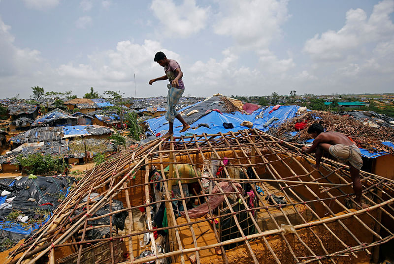 Rohingya refugees rebuild their makeshift house, which was destroyed by Cyclone Mora, at the Kutupalang Makeshift Refugee Camp in Cox`s Bazar. AFP