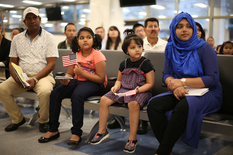 Yousha Yeana, 9, (2-L) and Raihanatul Hope, 4, (2-R) from Bangladesh attend a ceremony to present citizenship certificates to young people who earned citizenship through their parents, in Los Angeles, California, US, May 31, 2017. Reuters