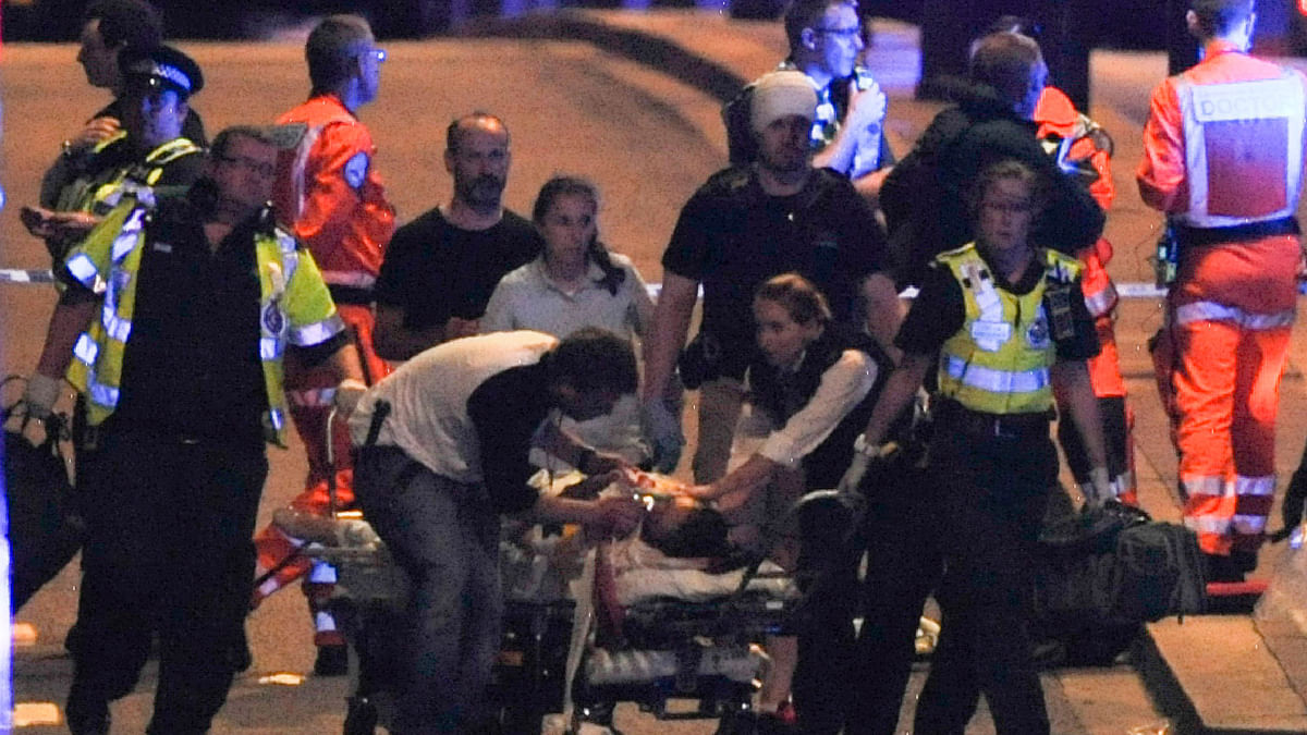 Police and members of the emergency services attend to victims of a terror attack on London Bridge in central London on June 3, 2017.