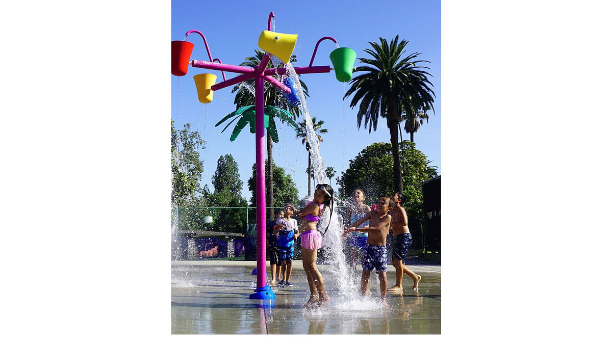 Children cool off on a hot summer afternoon at a water park using recirculated water in Alhambra, California on June 5, 2017. AFP