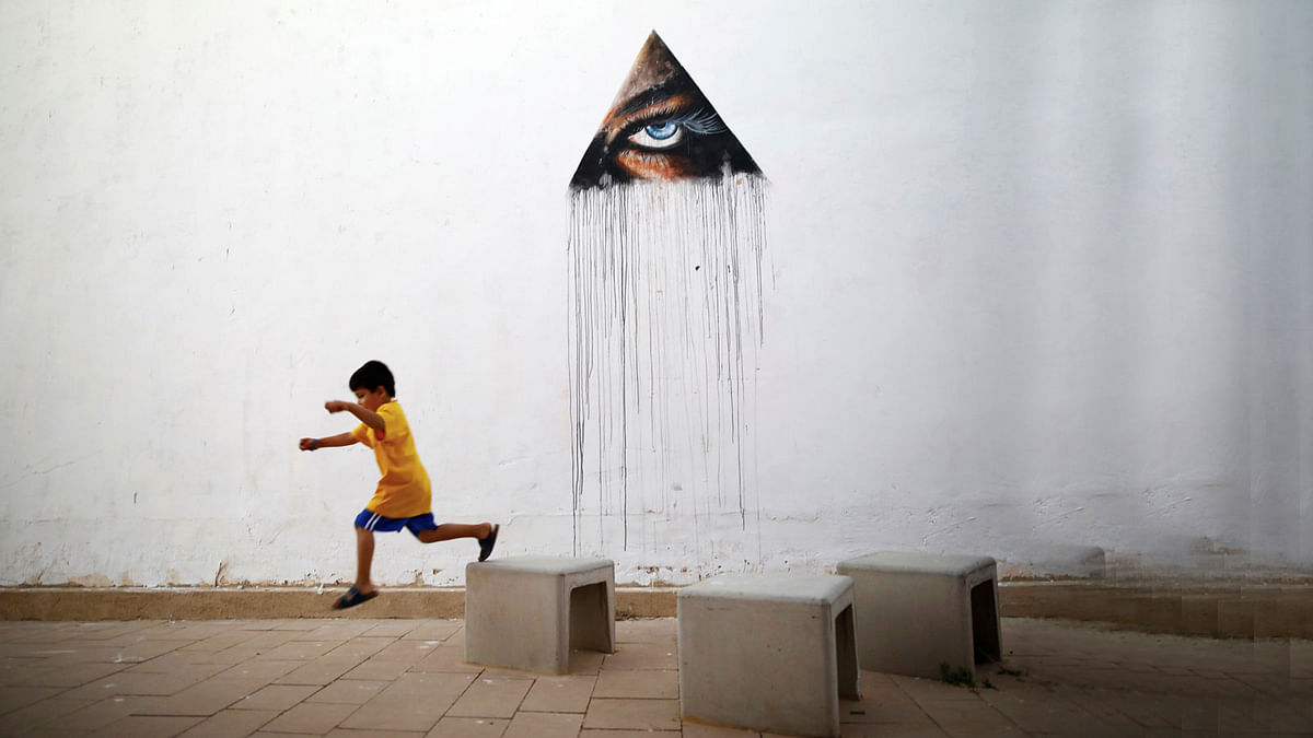 A boy plays in front of a wall painting by Hawaiian artist Kamea Hadar during an art happening, called POW! WOW! Israel, which is connected to a week-long art and culture festival held in Hawaii called POW! WOW! Hawaii, in the southern city of Arad. Reuters