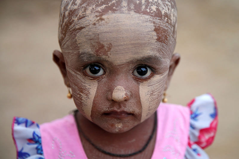 A girl wears thanakha powder on her face in a Rohingya refugee camp outside Kyaukpyu in Rakhine state, Myanmar. AFP