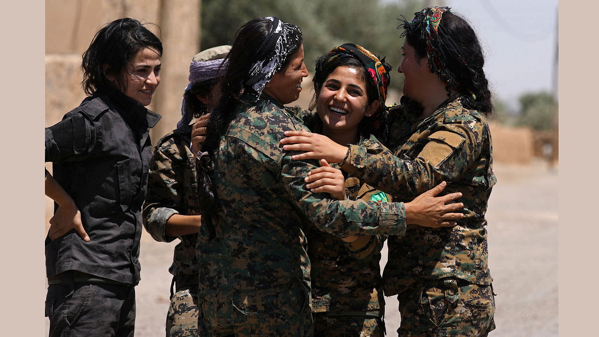 Syrian Democratic Forces (SDF) fighters greet a field commander (C) near Raqqa city, Syria June 7, 2017. Reuters