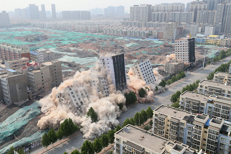 Buildings crumble during a controlled demolition for the reconstruction of urban villages in Zhengzhou, Henan province, China June 12, 2017. Picture taken June 12, 2017. Reuters