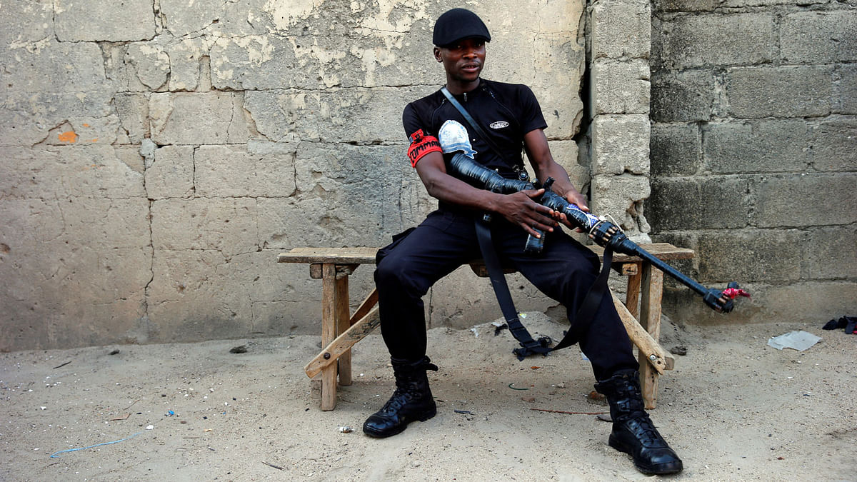 A member of the local militia group, otherwise known as CJTF, Bashir Ali, 22, poses for a portrait photograph in a compound in the city of Maiduguri, northern Nigeria June 5, 2017. Picture taken June 5, 2017. Reuters