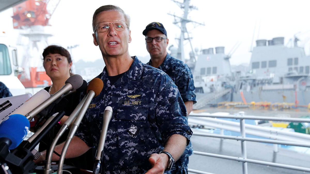 Vice Admiral Joseph Aucoin, U.S. 7th Fleet Commander, speaks to media on the status of the U.S. Navy destroyer USS Fitzgerald (seen behind him), damaged by colliding with a Philippine-flagged merchant vessel, and the seven missing Fitzgerald crew members, at the U.S. naval base in Yokosuka, south of Tokyo, Japan. Reuters