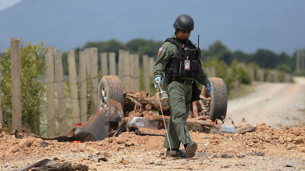 A Thai Army forensic team member inspects the site of a roadside bomb blast that targeted a Thai army patrol in southern Thailand`s Pattani province on June 19, 2017. AFP