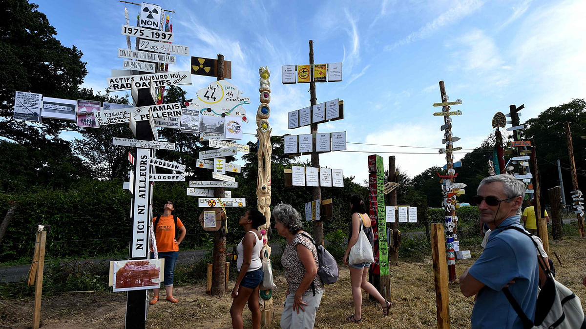 People stand in front of `totems` attend a two-day meeting organised by opponents to a controversial international airport project in Notre-Dame-des-Landes, western France. AFP
