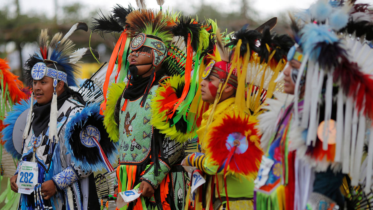Teen boys` fancy competitors stand before the judges after dancing on the second day of the 32nd Annual Taos Pueblo Pow Wow, a Native American dance competition and social gathering, in Taos, New Mexico, US. Reuters
