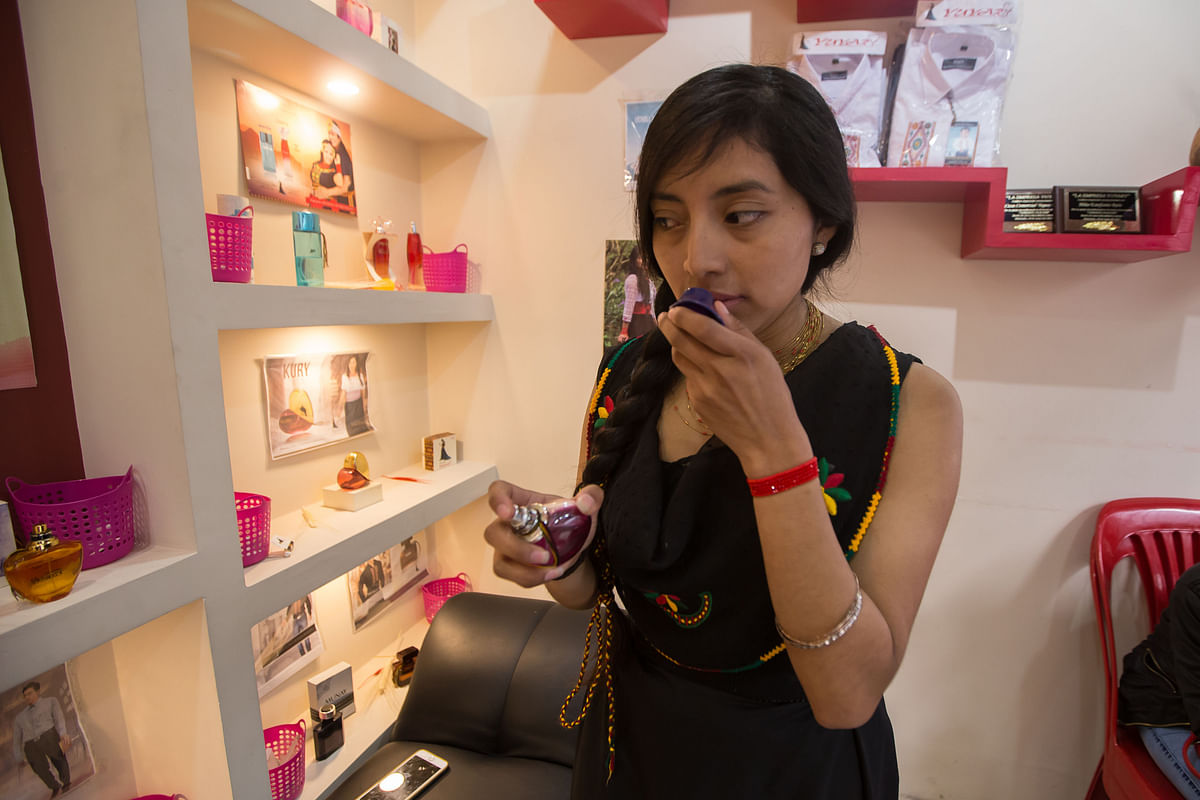 Esther Miranda, owner of a perfumery with fragrances whose names highlight the Puruha culture, speaks at her store in Riobamba, Ecuador on July 1, 2017. AFP
