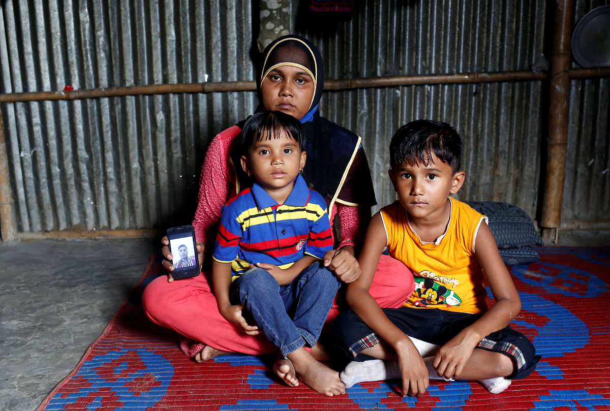 Noor Ankis, 25, whose husband Ayub, a leader of the unregistered makeshift camp in Kutupalong, was killed late last month, poses for a picture with her two children in Cox’s Bazar. Reuters