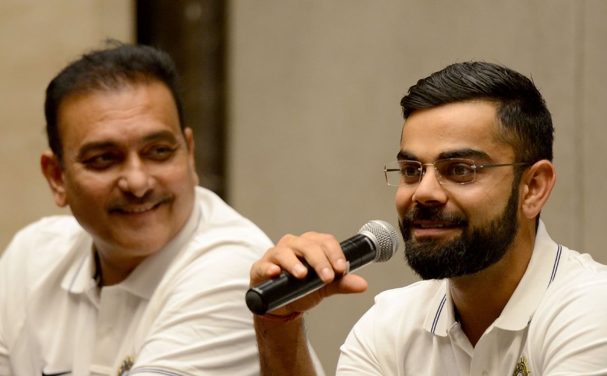Indian cricket team captain Virat Kohli ® speaks as newly-appointed coach Ravi Shastri looks on during a news conference before the national team’s departure for Sri Lanka, in Mumbai. Photo: AFP
