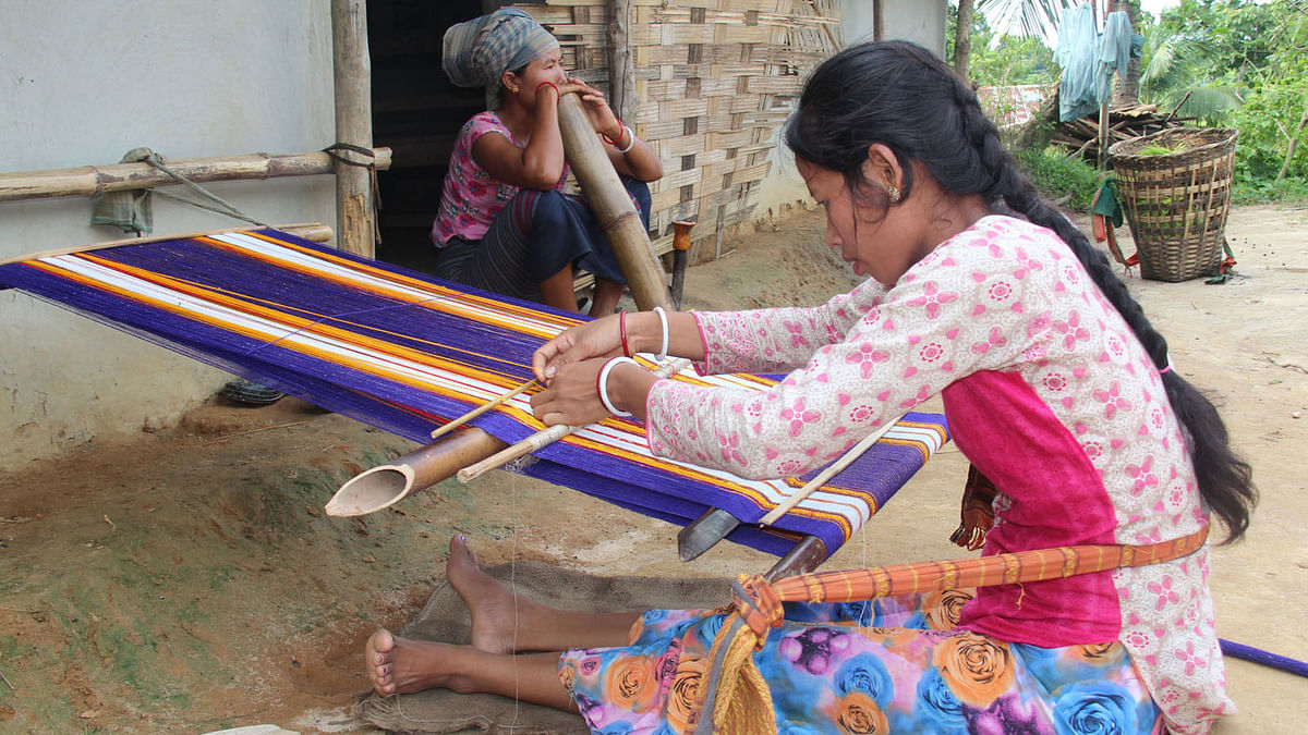 A Tripura community girl is weaving a ‘Risa’ (drape) at Chelachhara area in Khagrachhari sadar. Photo: Nirob Chowdhury