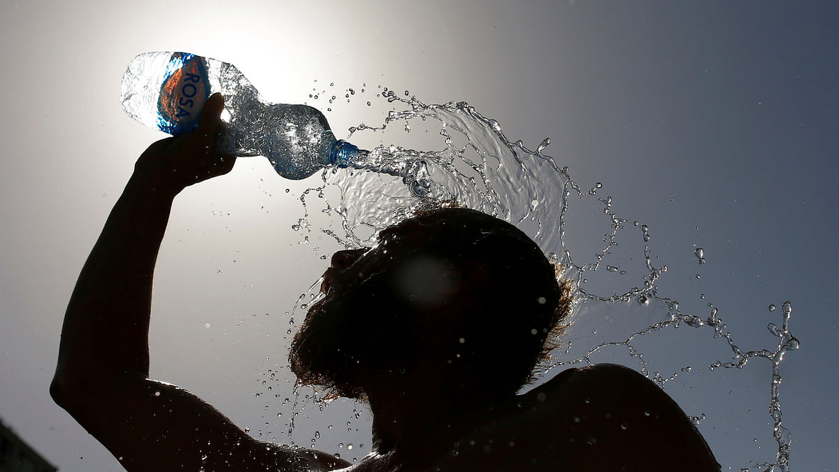 A man pours water on his face to cool off from hot weather in Skopje, Macedonia July 24, 2017. Reuters