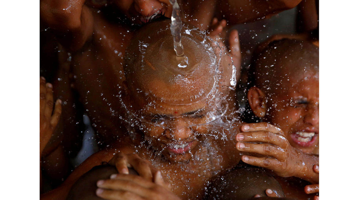Young Hindu priests take a holy bath together as part of a ritual during the sacred thread festival at the Pashupatinath temple in Kathmandu. Reuters