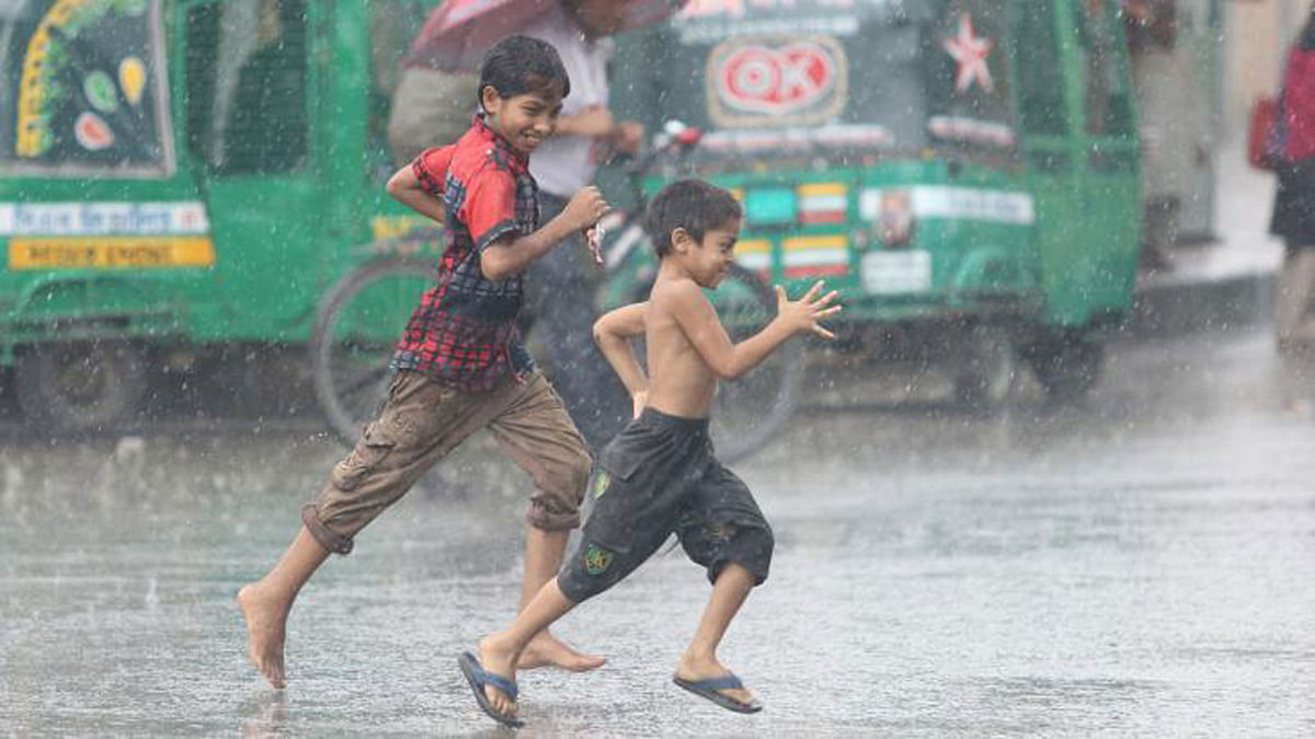 Children running to take shelter from rain on Saturday at Hatirjheel in the capital. Photo: Abdus Salam