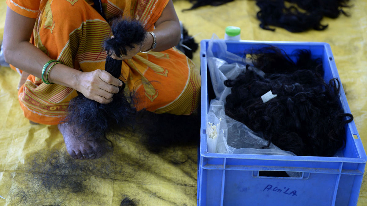 Indian worker processes human hair collected from local temples at Raj Hair International’s processing centre in Alinjivakkam, on the outskirts of Chennai. AFP file photo