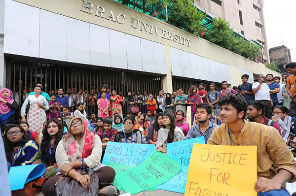 Students of BRAC University protesting in front of their Mohakhali campus over the sacking and ‘assaulting’ of a law teacher on Tuesday. Photo: Hasan Raja