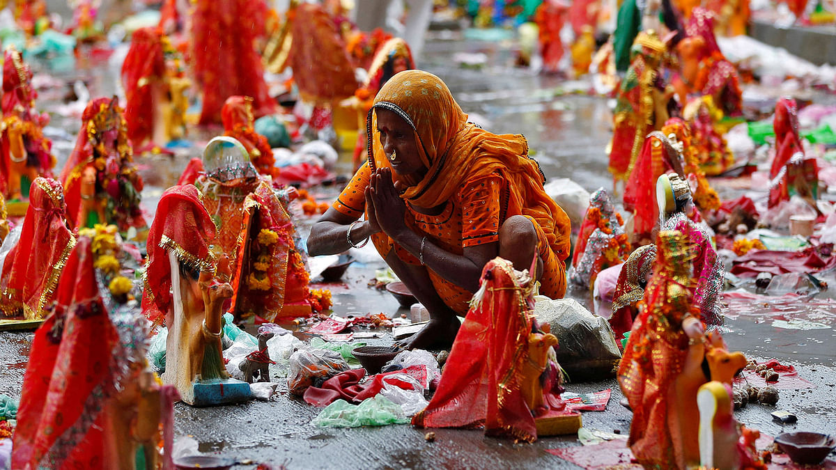 A devotee offers prayers to an idol, a day after `Dashama` festival during which Hindu devotees keep the idols of goddess Dashama in their house for ten days before immersing or keeping them near the banks of the Sabarmati river, in Ahmedabad, India, August 2, 2017. Reuters