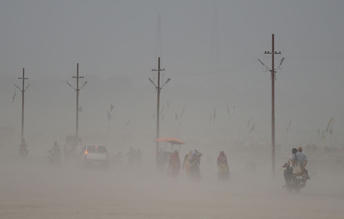 Indian pedestrians walking through a dust storm at the Sangam, the confluence of the Ganges, Yamuna and mythical Saraswati rivers in Allahabad. AFP file photo