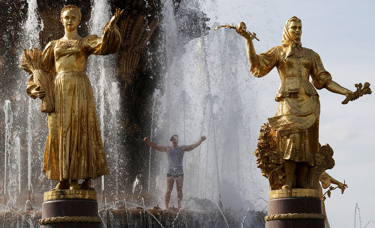 A former Russian paratrooper cools down in a fountain during Paratroopers` Day celebrations, on the grounds of the Exhibition of Achievements of National Economy in Moscow. Reuters