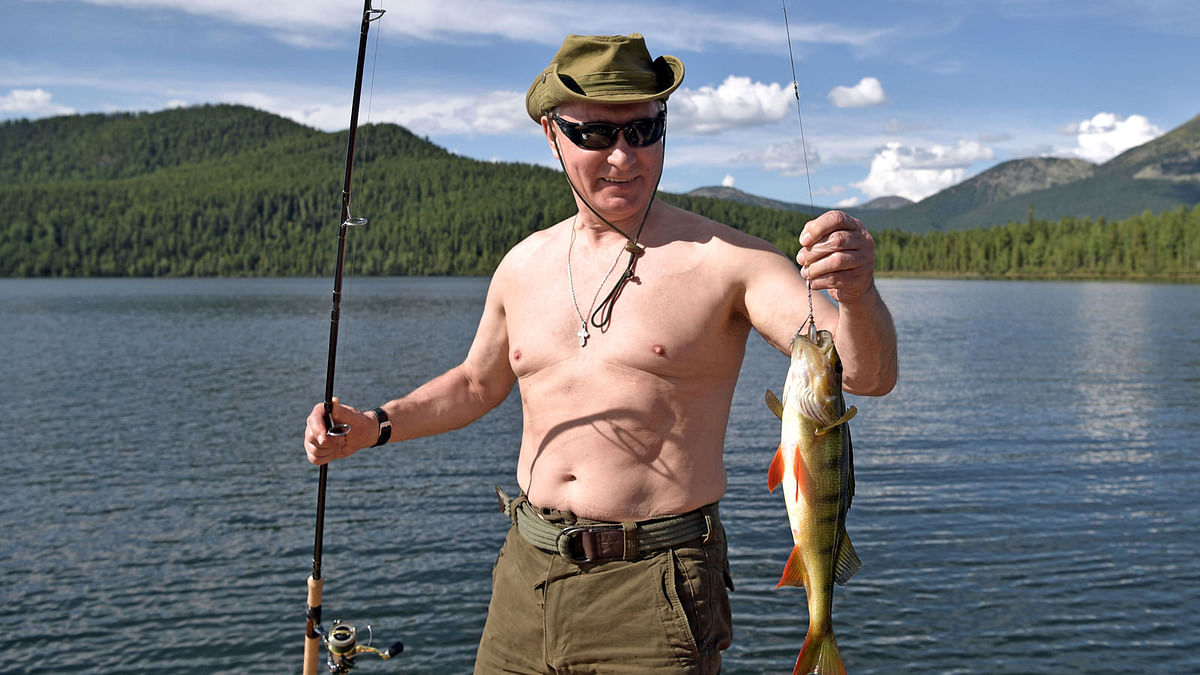 Russian president Vladimir Putin holds a fish he caught during the hunting and fishing trip which took place on 1-3 August in the republic of Tyva in southern Siberia, Russia, in this photo released by the Kremlin on 5 August, 2017. Photo: Reuters