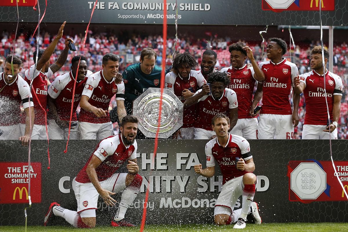 Arsenal players hold the shield as they celebrate victory after the English FA Community Shield football match between Arsenal and Chelsea at Wembley Stadium in north London on 6 August, 2017. Photo: AFP