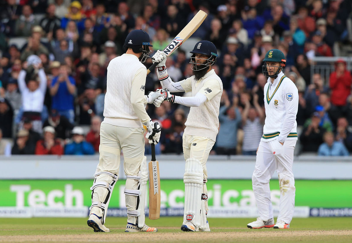 England’s Moeen Ali celebrates his half century on the third day of the fourth Test match between England and South Africa at Old Trafford cricket ground in Manchester. Photo: AFP
