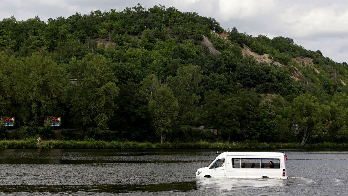 Robert Subik, a Czech constructor, drives his amphibious vehicle on the Vltava river in Prague. Reuters