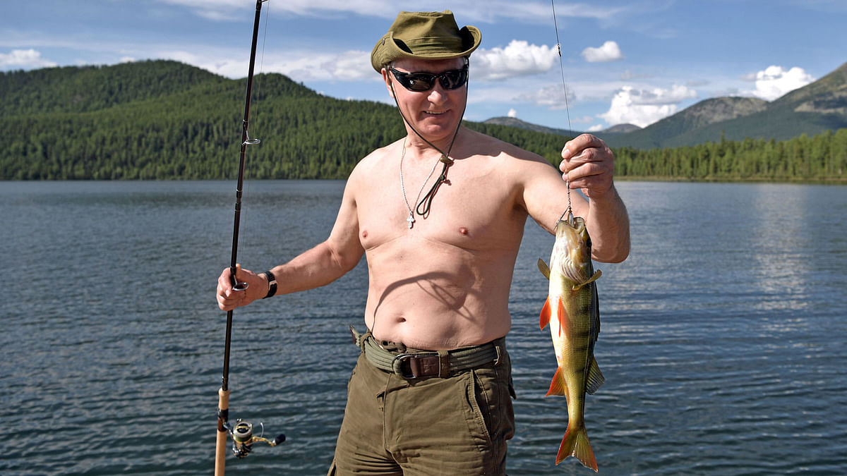 Russian President Vladimir Putin holds a fish he caught during the hunting and fishing trip which took place on August 1-3 in the republic of Tyva in southern Siberia. Reuters