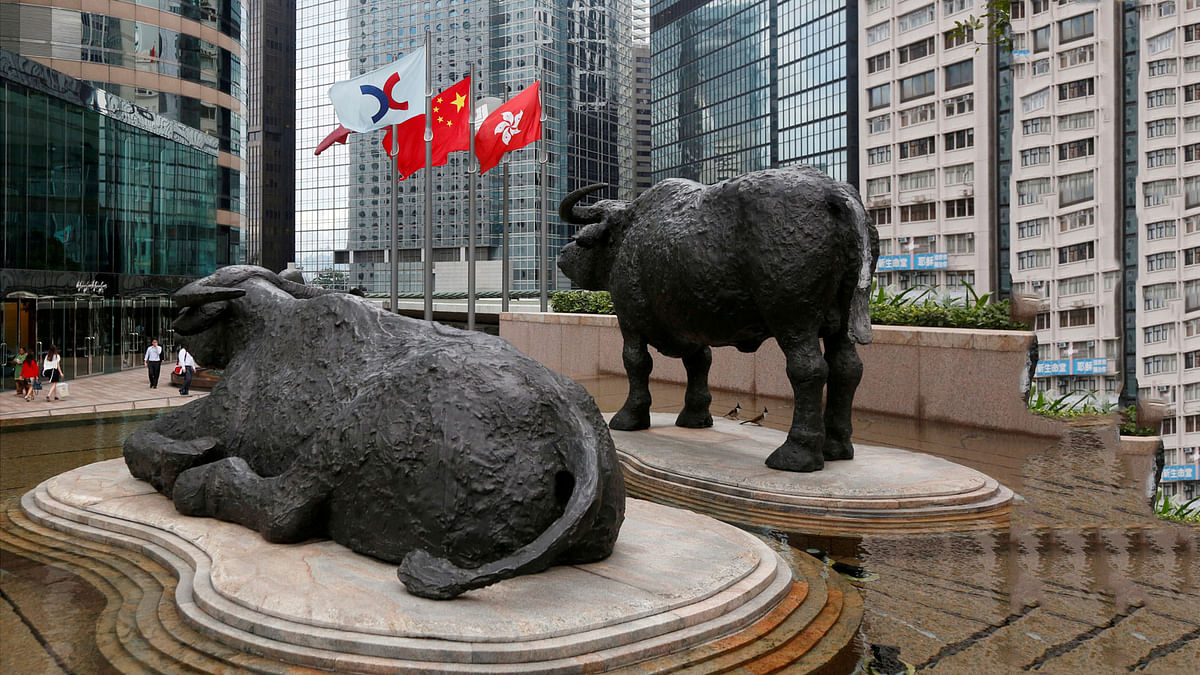 The Hong Kong Exchanges flag, Chinese national flag and Hong Kong flag are hoisted outside the Hong Kong Stocks Exchange. Reuters