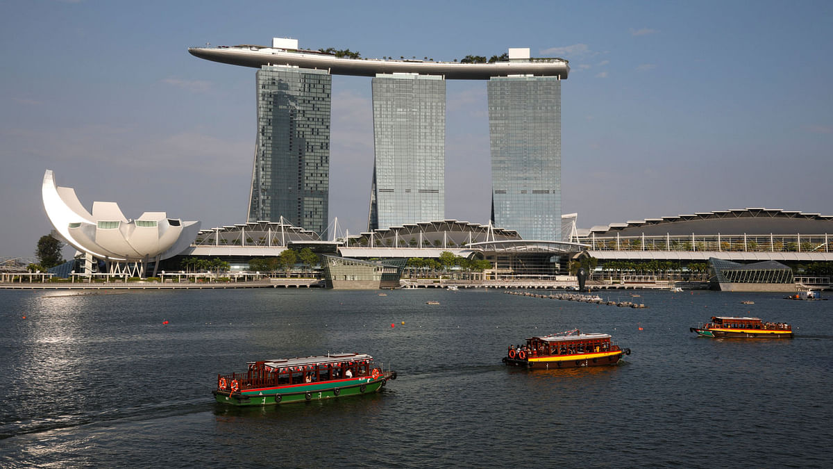Bumboats pass the Marina Bay Sands integrated resort in Singapore. AFP