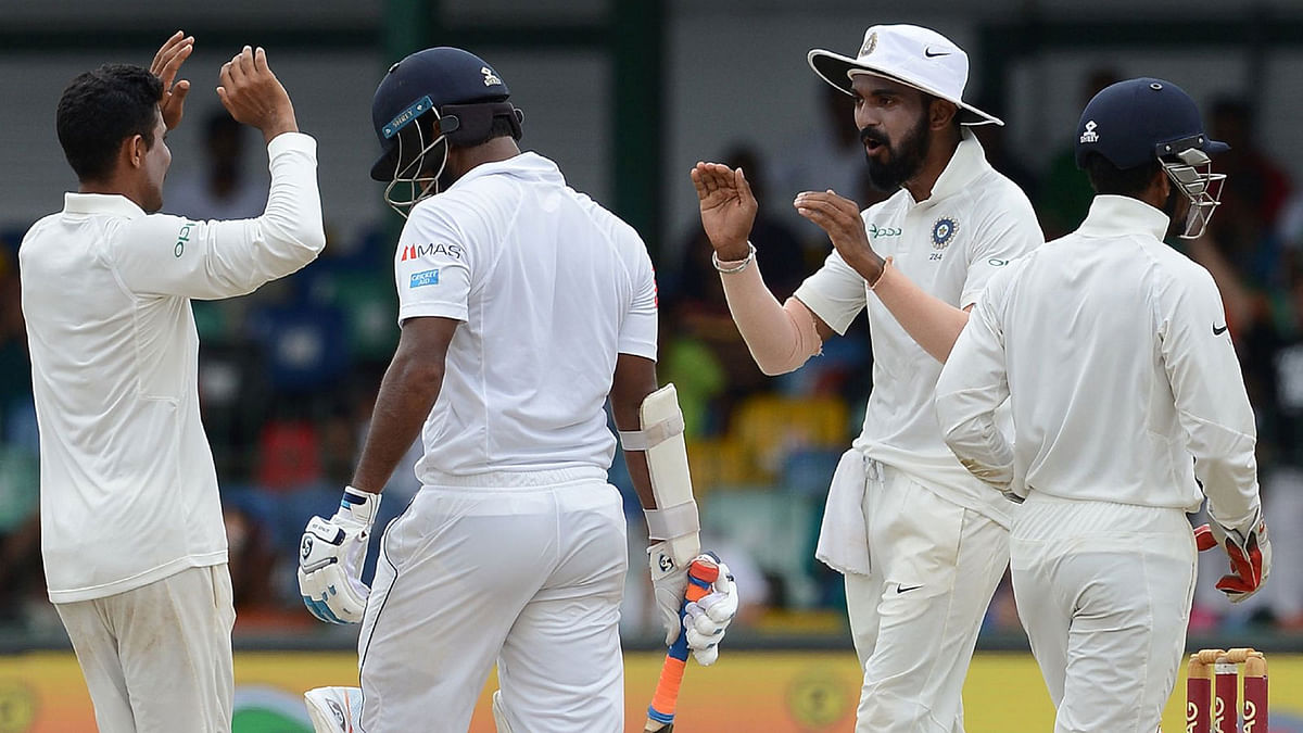 Indian cricketer Ravindra Jadeja (L) celebrates with teammates after dismissing Sri Lankan cricketer Dimuth Karunaratne (C) during the fourth day of the second Test match between Sri Lanka and India at the Sinhalese Sports Club (SSC) Ground in Colombo on August 6, 2017. AFP