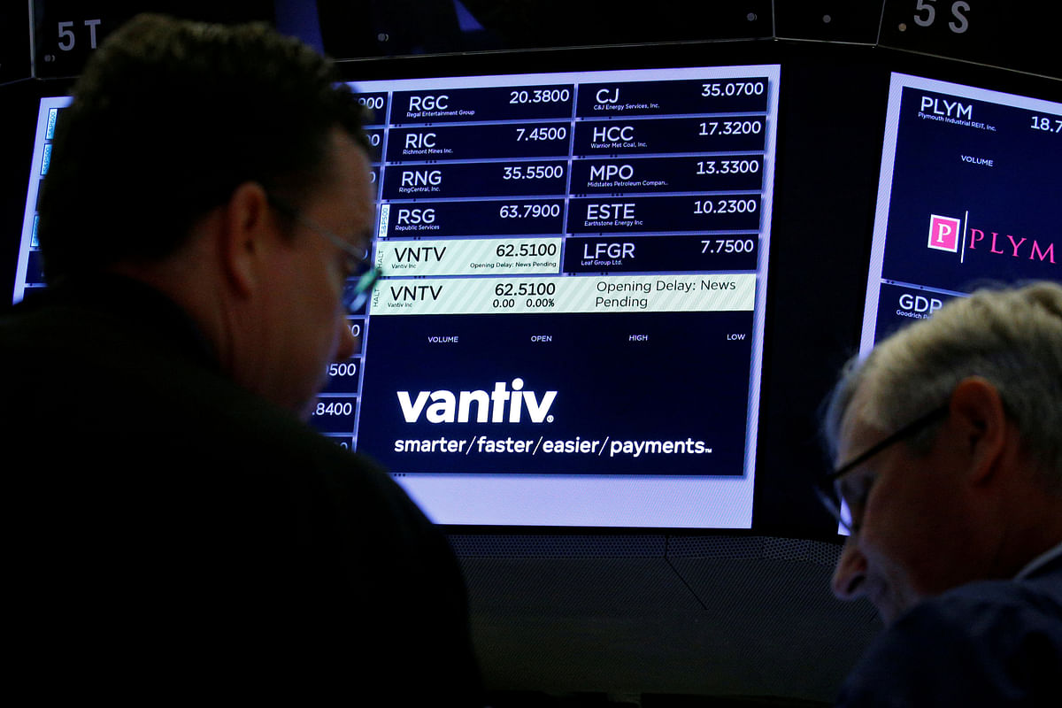 Traders wait for news at the post where US credit card technology firm Vantiv Inc is traded on the floor of the NYSE in New York. Photo: Reuters