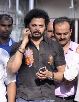 n this photograph taken on July 25, 2015, Indian cricketer Shanthakumaran Sreesanth speaks on his mobile as he leaves, following the judge`s pronouncement of the order discharging 36 accused in the IPL-6 spot fixing case, Patiala Court in New Delhi. AFP