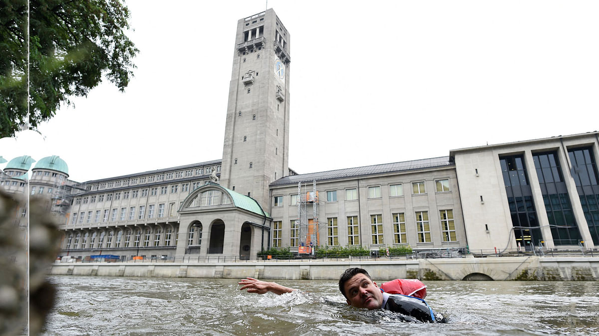 Benjamin David passes the Deutsches Museum as he swims from his home to his workplace along the Isar River in Munich. Reuters