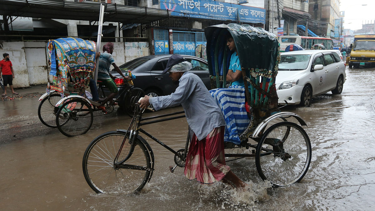 Potholes in Dhaka make the city dwellers suffer during the monsoon. Photo: Abdus Salam