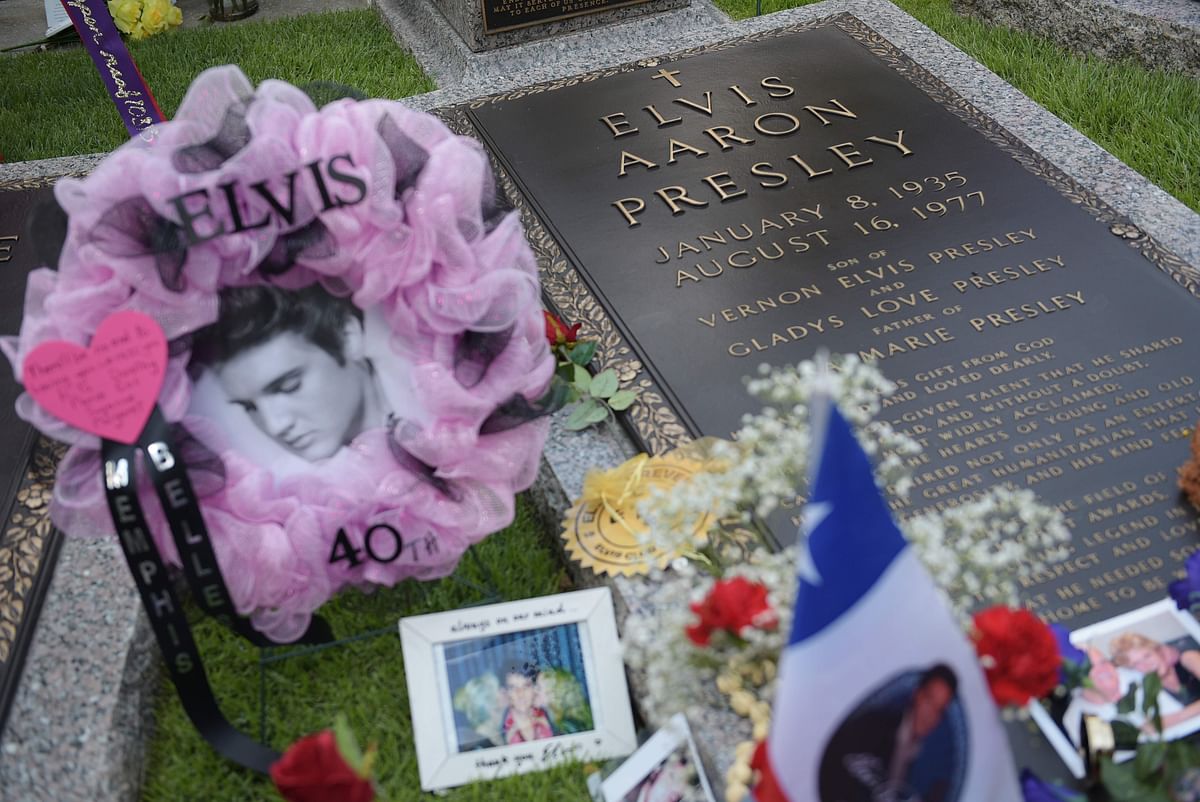 Tributes and momentoes are seen next to the grave marker for Elvis Presley in the Meditation Garden where he is buried alongside his parents and grandmother at his Graceland mansion on 12 August, 2017 in Memphis, Tennessee. Photo: AFP