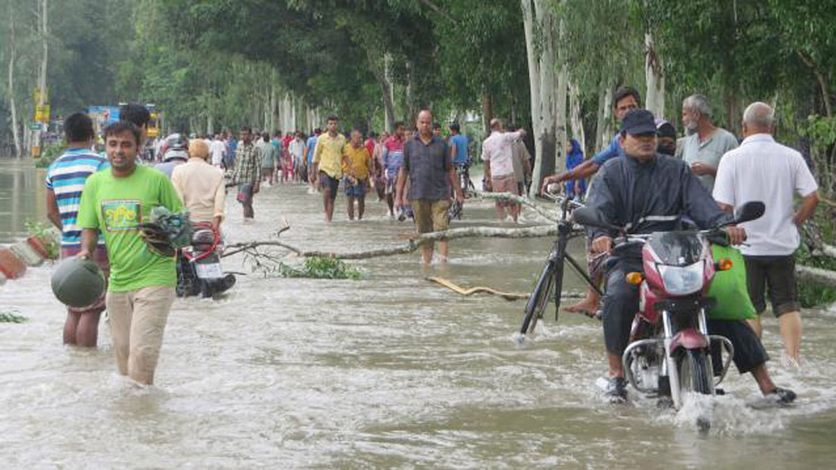 Floodwater flows over Dhaka-Dinajpur highway as flood situation deteriorated in the country`s northwest and northeast regions. Photo: Mohammad Ali