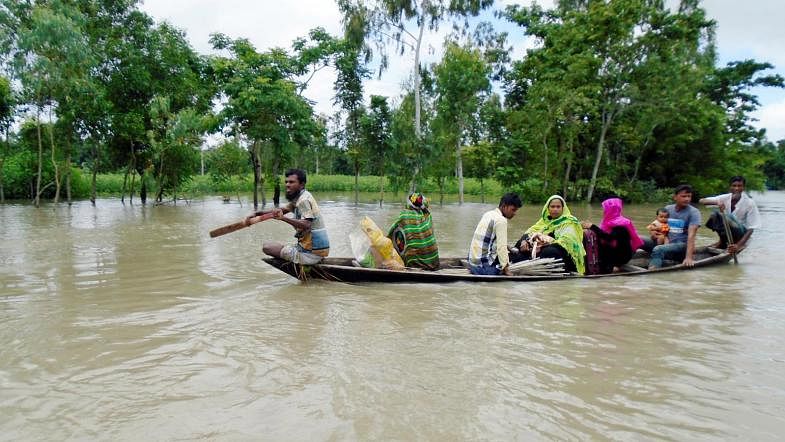 Locals are moving to shelter centres by boat as four upazilas of Jamalpur inundated. Jamuna river has swollen up for excessive rainfall and upstream water on Monday. Photo: Prothom Alo