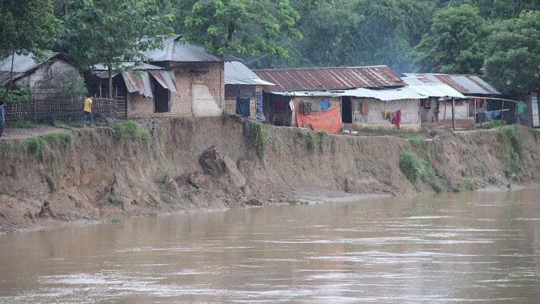 Chengi river in Khagrachhari eroding due to incessant rains on Monday. Quite a number of houses have been eroded into the river already. Photo: Nirob Chowdhury