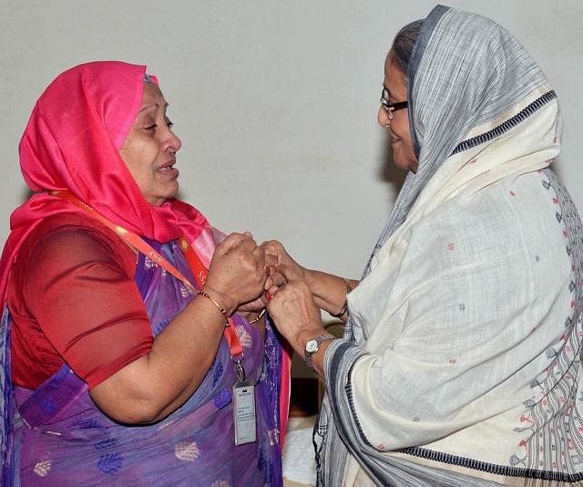 Prime minister Sheikh Hasina hands over financial assistance to film actress Anwara Begum. Photo: Prothom Alo