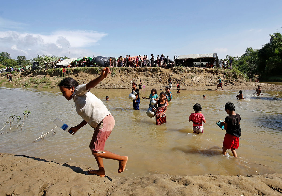 Rohingya children cross the cannel to collect drinking water from Bangladesh side, who take shelter in No Man’s Land between Bangladesh-Myanmar border, in Cox’s Bazar. Reuters
