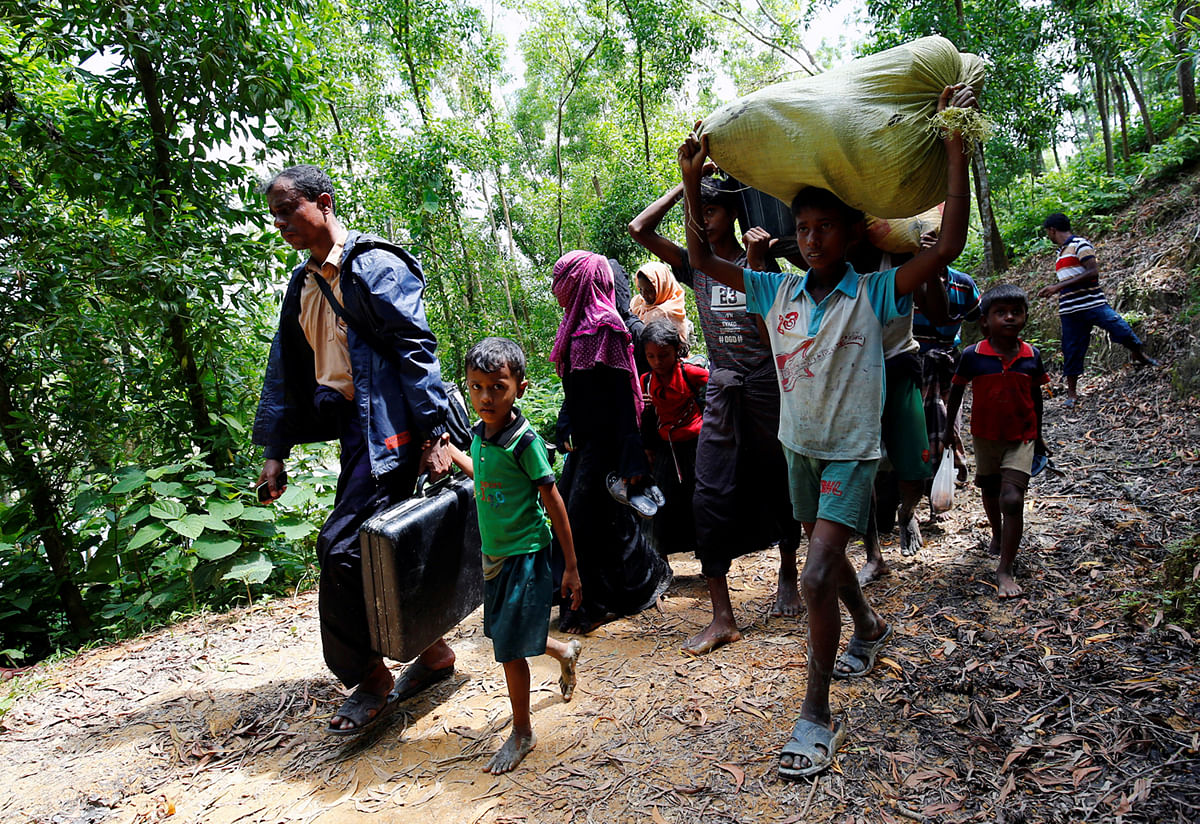 Rohingya people walk towards the makeshift shelter near the Bangladesh-Myanmar border in Cox’s Bazar. Reuters