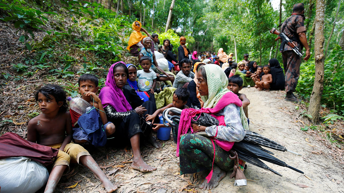 Rohingya people sits on the Bangladesh side as they are restricted by the members of Border Guards Bangladesh (BGB), to go further inside Bangladesh, in Cox’s Bazar, Bangladesh August 28, 2017. Reuters