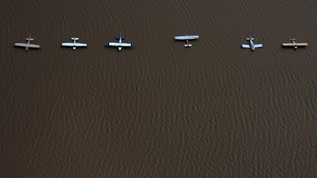 Planes are surrounded by flood waters caused by Tropical Storm Harvey at the West Houston Airport in Texasacuate neighborhood left flooded by Tropical Storm Harvey in West Houston, US. Reuters