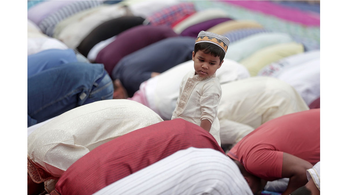 Child stands as people pray to mark Kurban-Ait, also known as Eid al-Adha in Arabic, in downtown Rome. Reuters