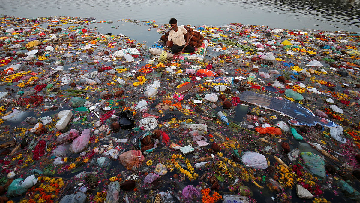 A man collects items thrown as offerings by worshippers into the Sabarmati river, a day after the immersion of idols of the Hindu god Ganesh, the deity of prosperity, in Ahmedabad, India, on 6 September 2017. Photo: Reuters