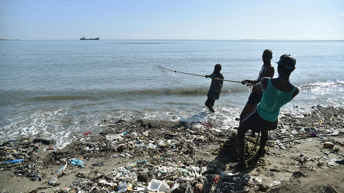 Fishermen pull a net while fishing in Cap-Haitien, Haiti, on 6 September 2017. Inhabitants of Shada, a poor riverside community in Cap-Haitien, were surprised to learn that a massive, potentially catastrophic hurricane was headed their way. They are in mortal danger from Irma, but nobody had bothered to warn them. Photo: AFP