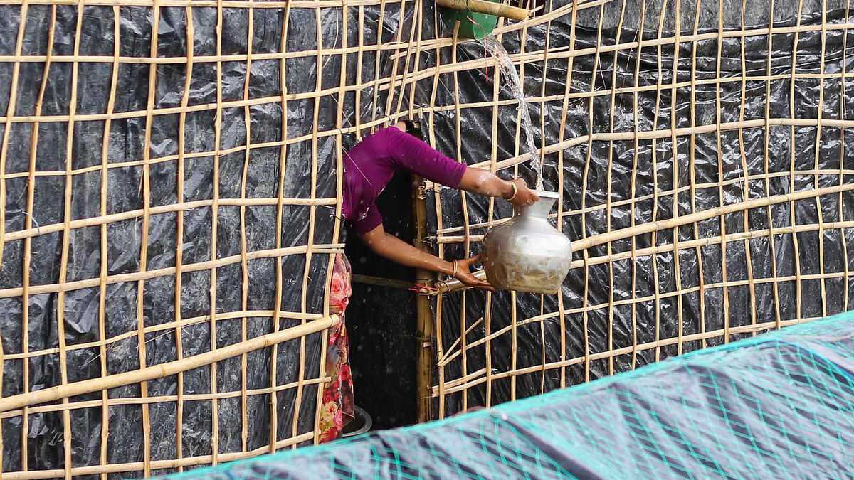 Facing acute water shortage in the camps, Rohingyas collect rainwater at the Balukhali camp on Wednesday. Photo: Abdus Salam